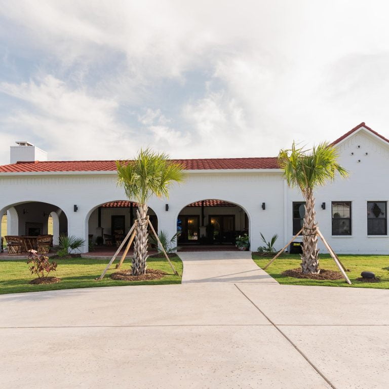 Spanish colonial building with palm trees at glen rose resort